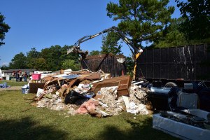 Columbia, SC, October 13, 2015 -- Residents watch their flood damaged belongings get loaded into a truck as debris removal begins in this neighborhood. FEMA/Bill Koplitz