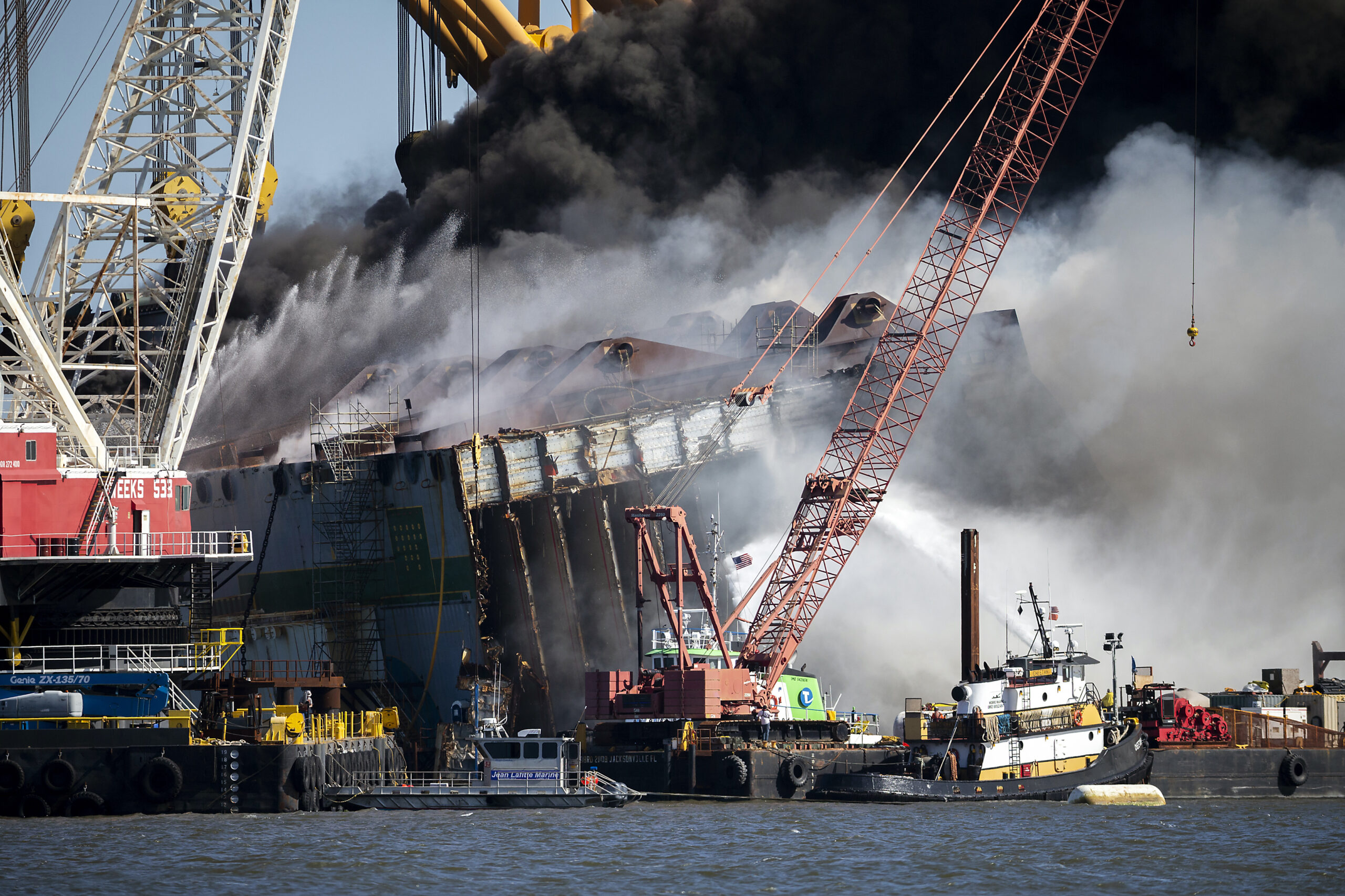 Damage Assessment Begins on Overturned Cargo Ship After Fire